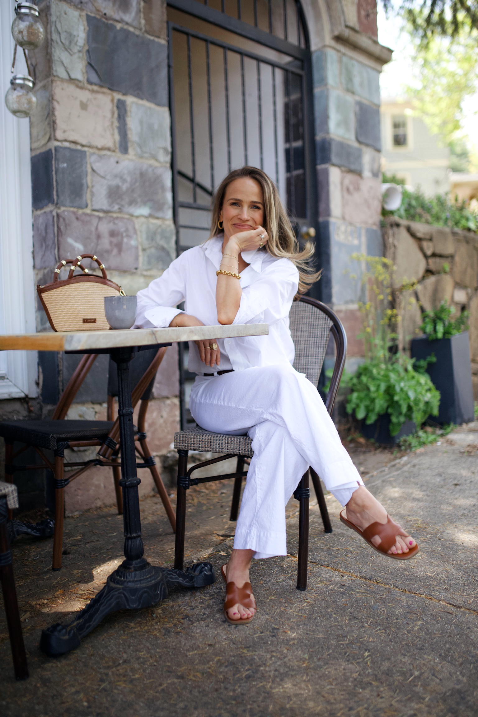 Woman wearing white top and pants by Frank & Eileen